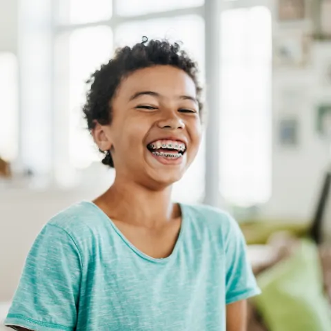 Child with braces smiling