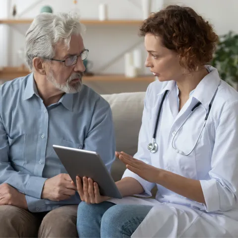 An older man speaks to his doctor