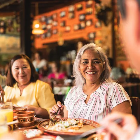 A group of adults having dinner at a restaurant.