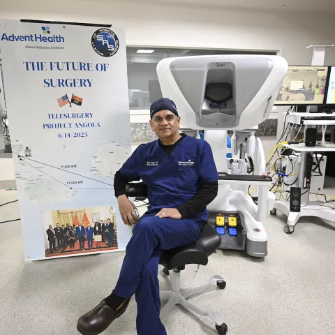 Dr. Vip Patel with Angola surgery banner