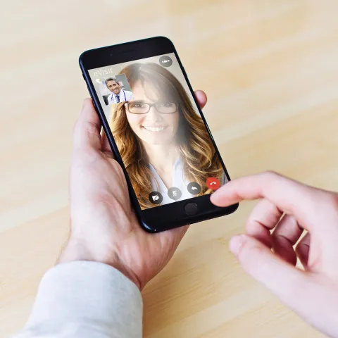 Doctor caring for his patient through our video visit app.