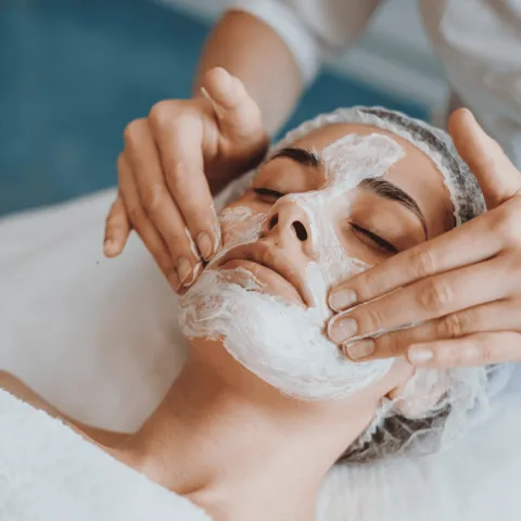 A woman receiving a facial.