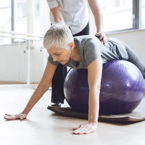 woman exercising with a fitness trainer