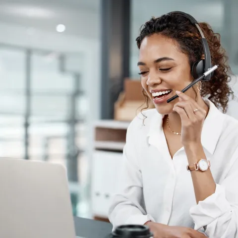 Female Professional using a laptop and headset