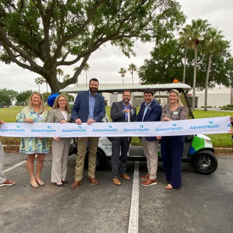 Leaders from AdventHealth Heart of Florida, AdventHealth Polk Foundation and HOAR Construction cut the ribbon for the new visitor shuttle during a special ceremony.