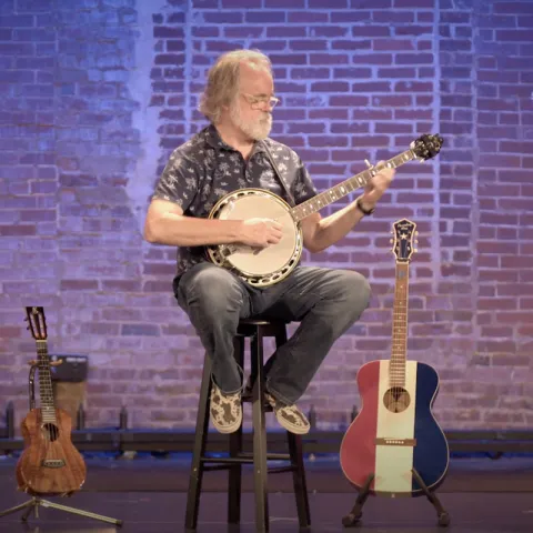 Jim Pankey playing banjo on stage
