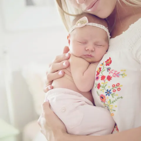 A mother holding her baby.
