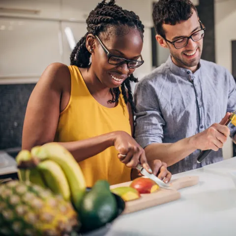 A couple slicing mango.