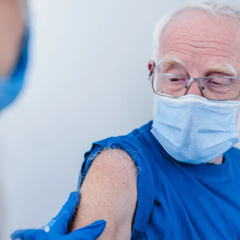 An elderly man getting his vaccination shot