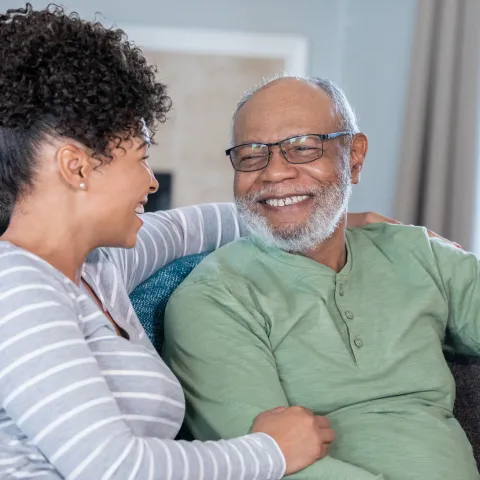 A family hugging on the couch.