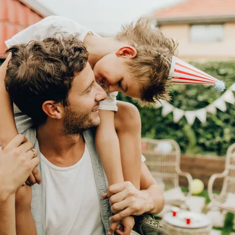 A father and son celebrate Independence Day at home.