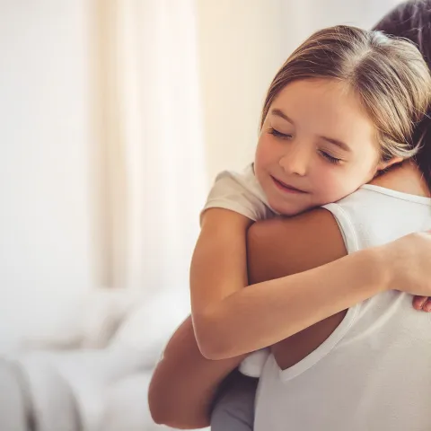 Young child embracing her mother
