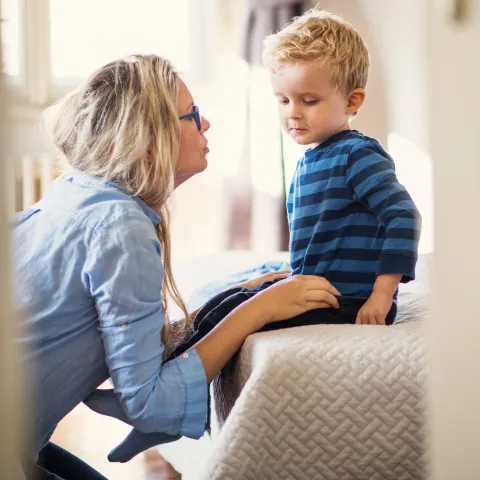 A mother comforts her young son.