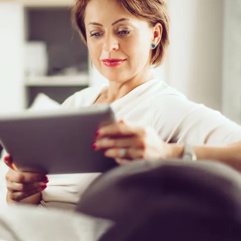 Older Female Reading on Couch