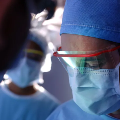 A team of physicians in the middle of a surgery