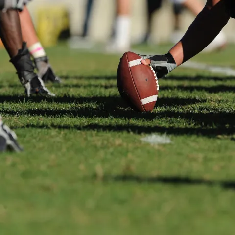 Football players practicing on a field.