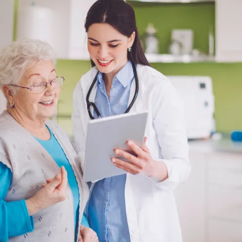 A woman reviews her test results with her doctor.
