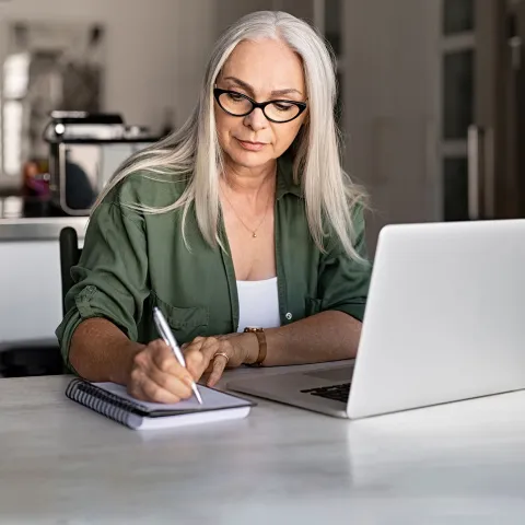 Woman with planner and laptop.