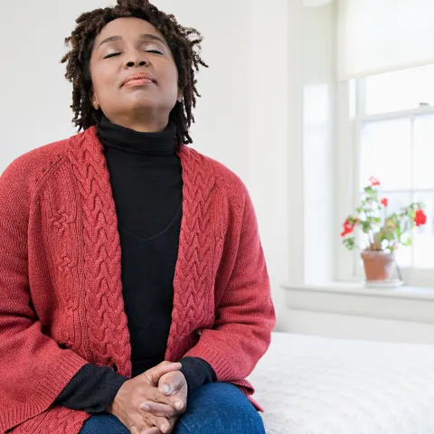 A woman says a prayer of gratitude.