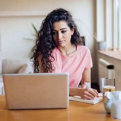 young-woman-taking-notes-pensive