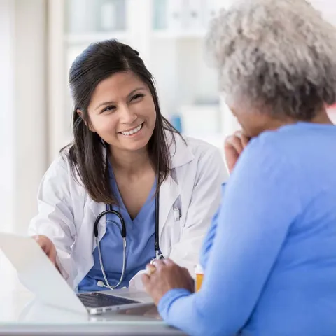 Female doctor talking to female patient