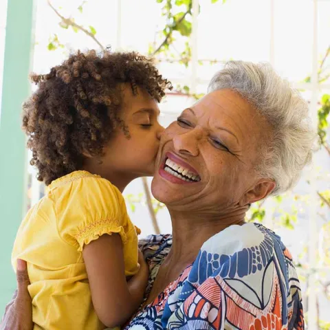 Grandmother being kissed by child