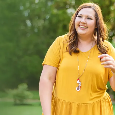 woman outside in yellow dress