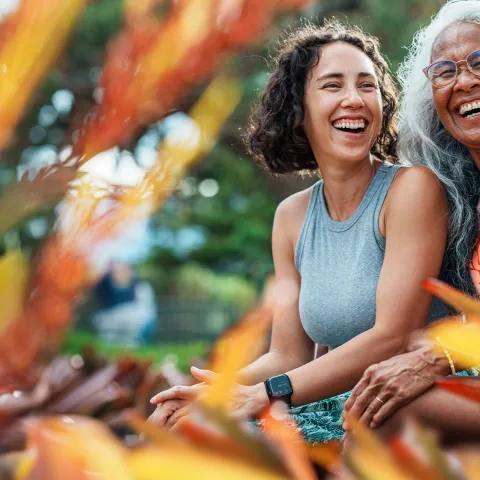 mom and daughter smiling in a garden