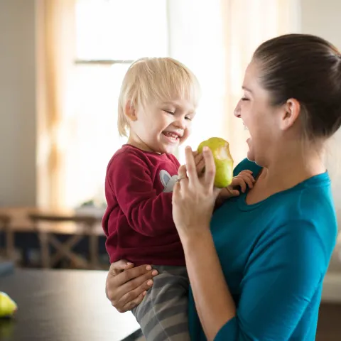 Mom and Child having a Snack in the Kitchen