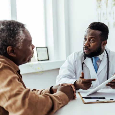Older man talking with his doctor