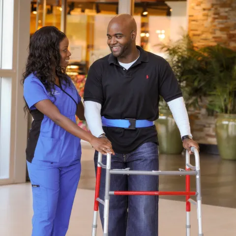 Nurse helping patient during therapy session. 