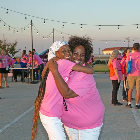 Two Shine the Light Volunteers Hug at the Wrap Party