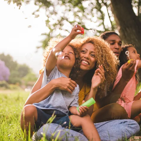 A family blowing bubbles together outdoors
