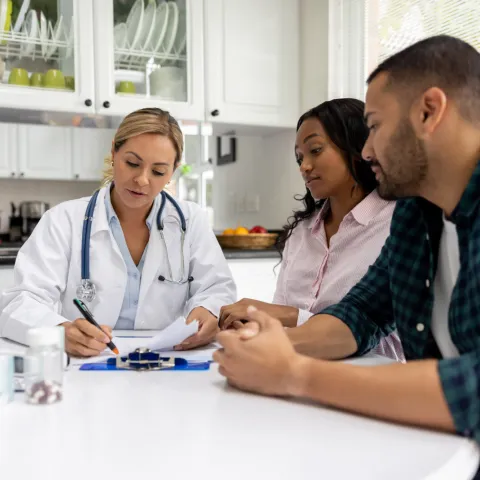 A couple talks to their doctor about fertility.