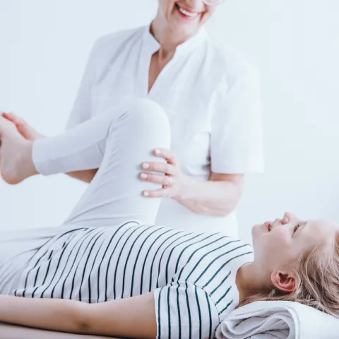 woman helping girl with arthritis pain