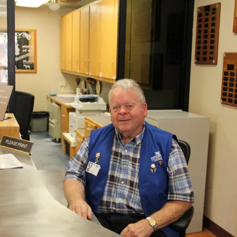 AdventHealth Ottawa Volunteer Warren at the front desk.