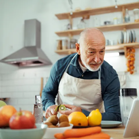 Older man preparing a healthy meal.