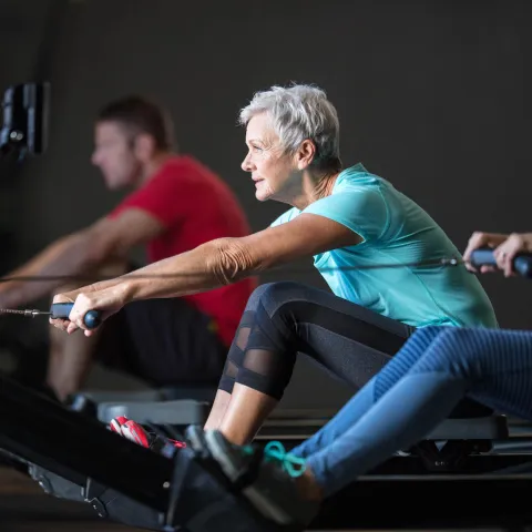 Woman on a rowing machine.