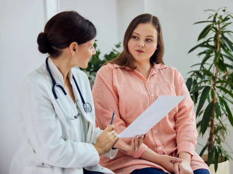 A Doctor Goes Over a Chart with a Patient