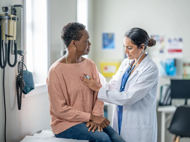 A Doctor Check's Her Patient Breathing with a Stethoscope 