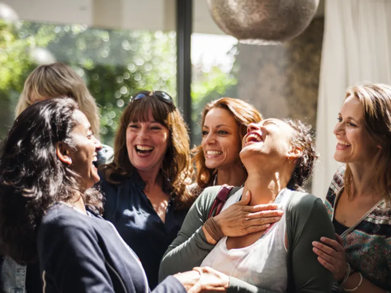 A group of women laugh together.