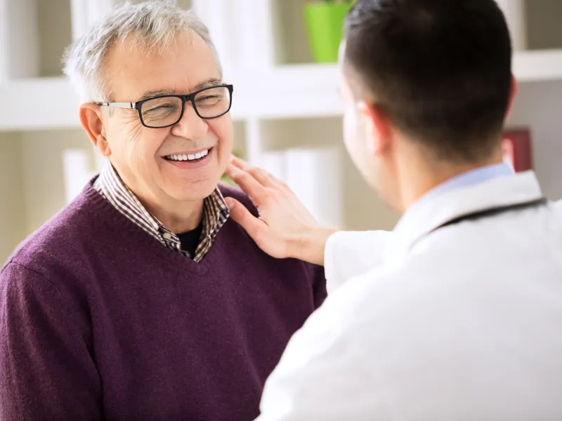 Smiling man visits doctor