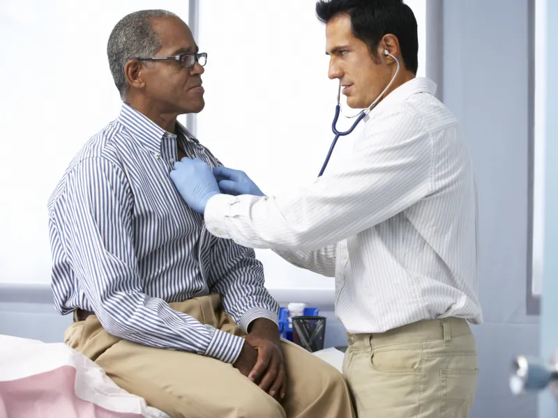A doctor uses a stethoscope to listen to a patient's healthy heart.