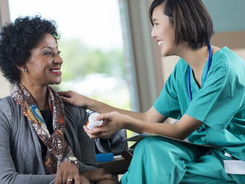 A nurse answers a woman's health questions.