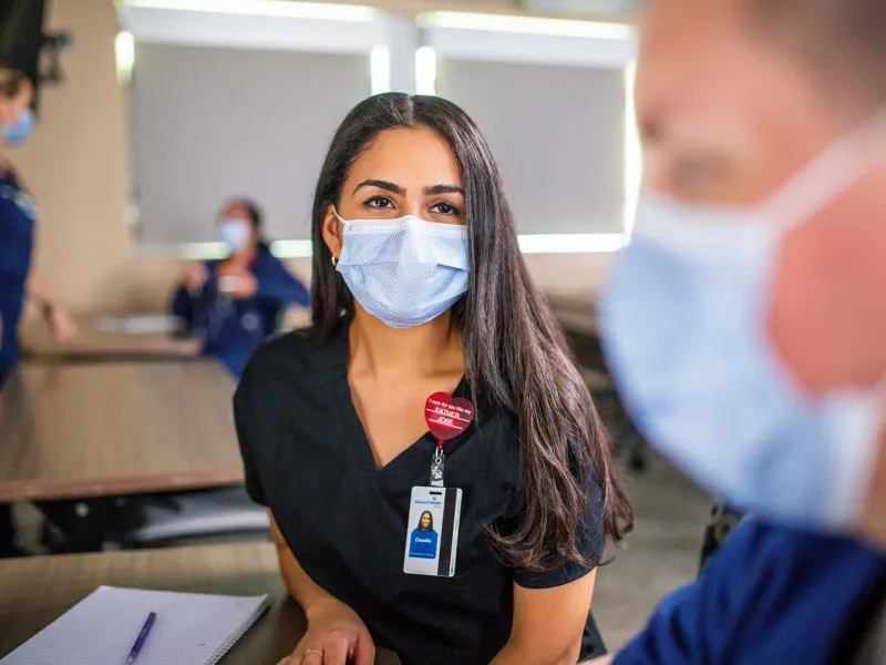 An AdventHealth nurse focused in a talk with another nurse