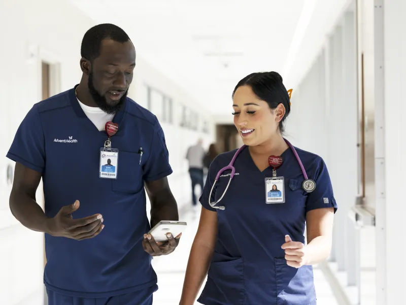 two adventhealth nurses looking at each other