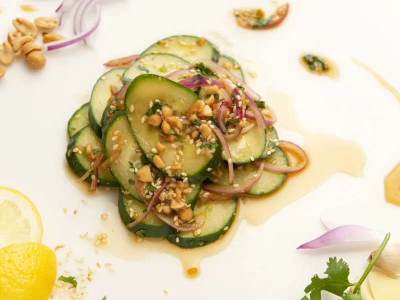 Mound of cucumber salad with lemon garnish