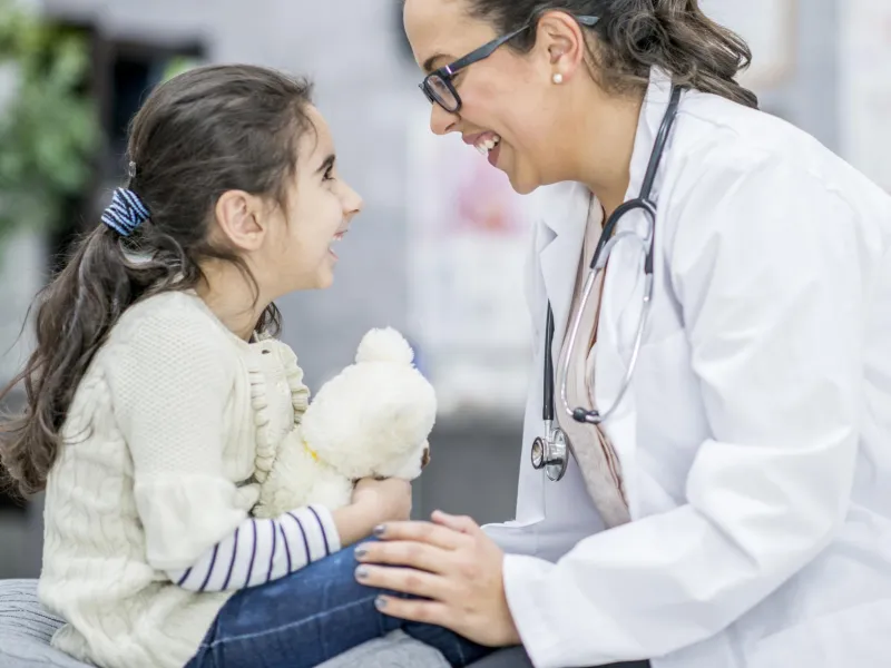 Child smiling at her doctor