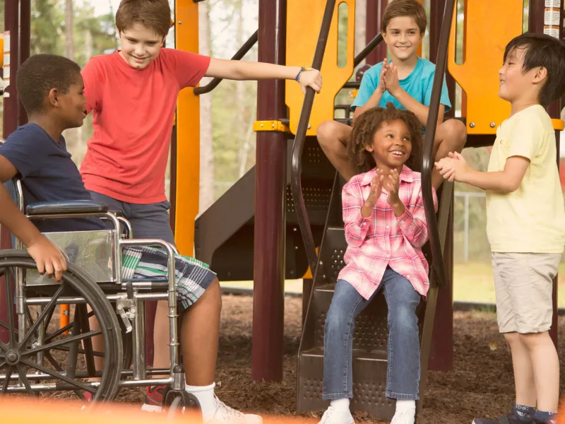 A group of kids talking at the playground
