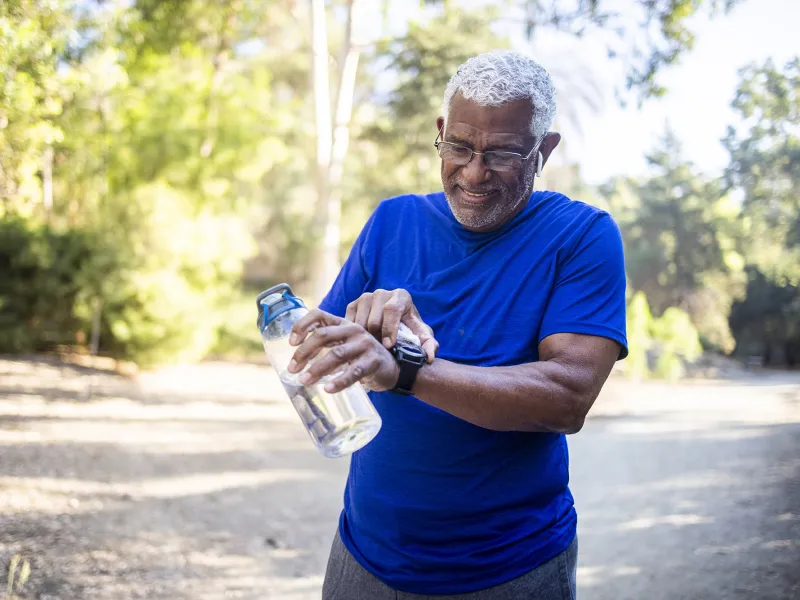 Older man checking his time during a run